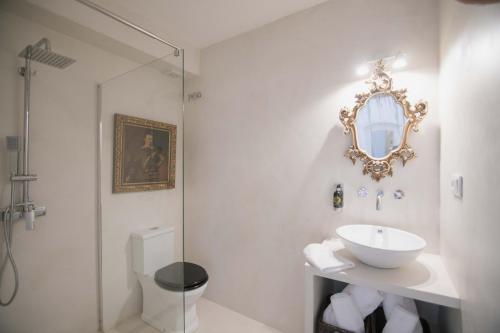 a white bathroom with a sink and a mirror at Villa Dora (Only adults) in Jávea