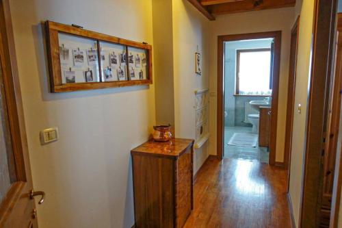 a hallway of a bathroom with a sink and a mirror at Casa Francesca - Relax nel cuore delle Dolomiti in Pieve di Cadore