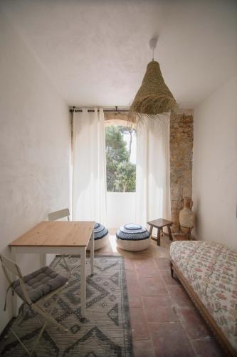 a room with a table and a bed and a window at Villa Dora (Only adults) in Jávea