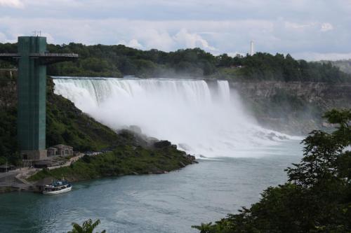 a large waterfall with a boat in front of it at Ellis House Bed & Breakfast in Niagara Falls