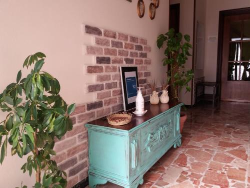 a blue cabinet in a room with a brick wall at B&B Casa Piras IUN3880 in Barùmini