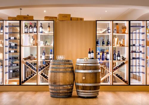 a wine cellar with two wooden barrels in front of a store at Evora Hotel in Évora