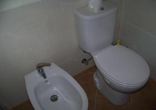 a bathroom with a white toilet and a bidet at Casa da Praia Apartment - Alvor Beach in Alvor