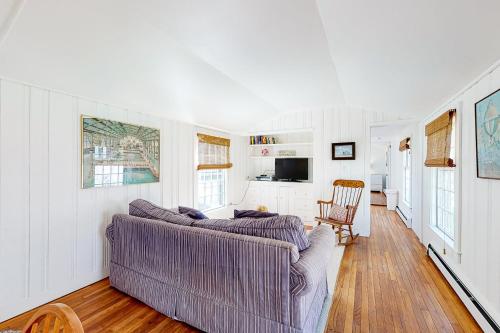 een woonkamer met een bank en een stoel bij Vineyard Charm in Edgartown