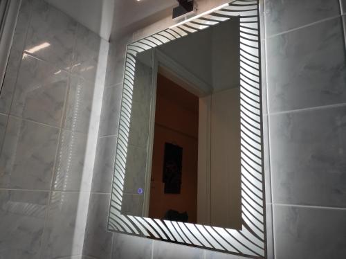 a mirror on a wall in a bathroom at Fantastic View Studios Kythnos in Kithnos