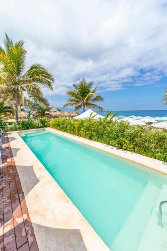 a swimming pool with the ocean in the background at Suites at Sapphire Ocean Club in Puerto Vallarta