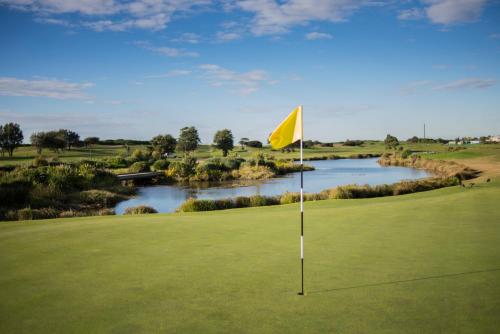 a golf course with a yellow flag on the green at Best Western City Sands in Wollongong