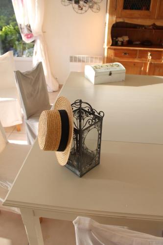 a straw hat sitting on a white table at A L'Orée du Bois in Rétaud