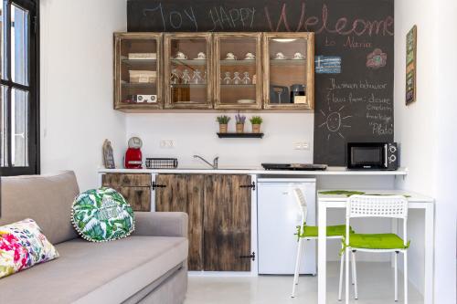 a kitchen with a couch and a table and a counter at Naria Medieval House in Rhodes Town