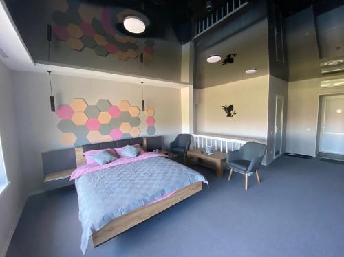 a bedroom with a bed and a wall with hearts at Апартаменты Well - Being in Umanʼ