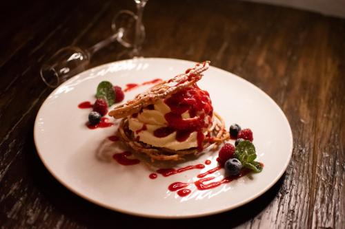 a white plate with a dessert on a wooden table at Landhof Steinbäck in Sankt Stefan ob Stainz