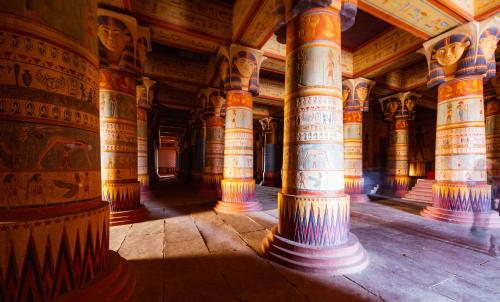 a large building with columns and paintings on the walls at Oscar Hotel by Atlas Studios in Ouarzazate