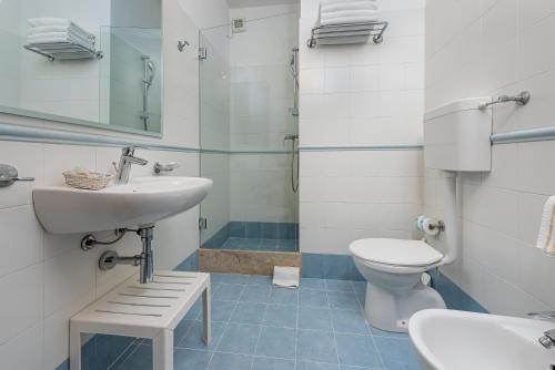 a bathroom with a sink and a toilet at Hotel Al Paradise in San Vito lo Capo