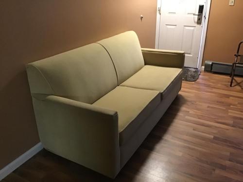 a couch sitting in a living room at Bellevue Hotel and Suites in Bellevue