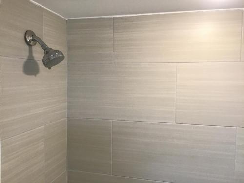 a bathroom with a shower with a light on the wall at Bellevue Hotel and Suites in Bellevue