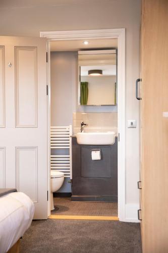 a bathroom with a sink and a toilet at Turl Street Mitre in Oxford