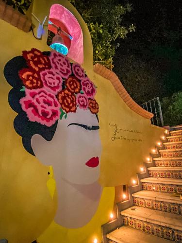 a painting of a woman with flowers on her head at Hotel Boutique Santo Cuervo in Bernal