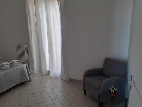 a living room with a chair and a table at TAGLIAMENTO APARTMENT in Vieste