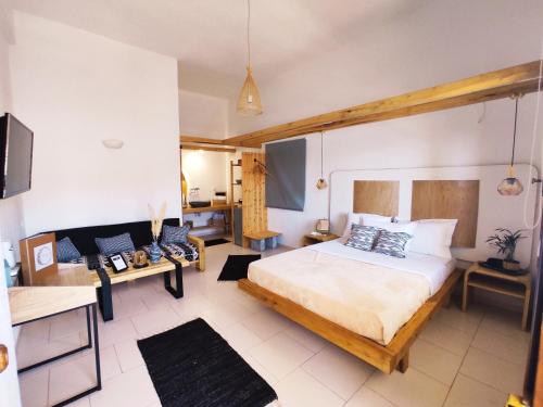 a bedroom with a large bed in a room at Spongia Apartments Kalymnos in Kalymnos