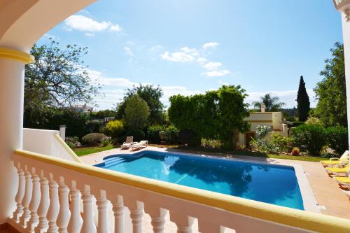 a swimming pool on the balcony of a house at Villa Ligia by ALgest in Portimão