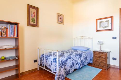 a bedroom with a bed and a book shelf at Locazione Turistica da Placida in Suni