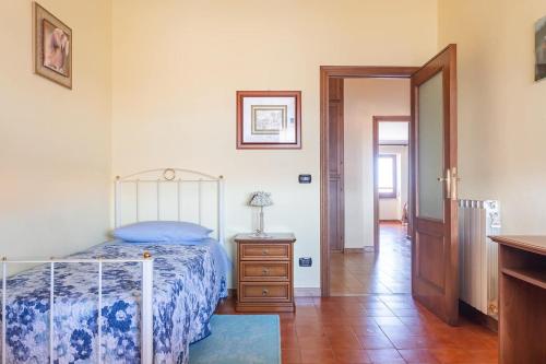 a bedroom with a bed and a wooden floor at Locazione Turistica da Placida in Suni