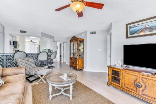 a living room with a flat screen tv and a couch at Sand and Sea Enjoyment Retreat in Ormond Beach