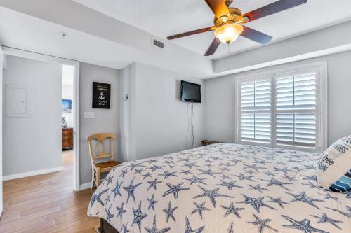a bedroom with a bed and a ceiling fan at Sand and Sea Enjoyment Retreat in Ormond Beach