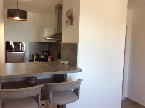 a kitchen with a table and chairs in a room at Poseidon in Cagnes-sur-Mer