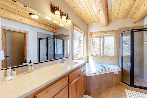 a bathroom with a tub and a sink and a mirror at Ski-View Lodge in Brian Head