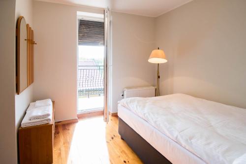 a bedroom with a bed and a large window at Dom z widokiem na jezioro Tajty - Wilkasy Zalesie in Giżycko