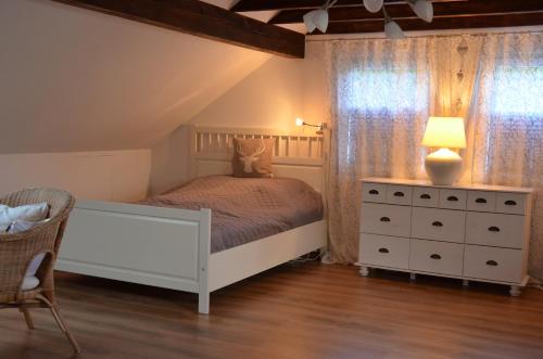 a bedroom with a bed and a dresser and a lamp at Grimming View in Niederöblarn