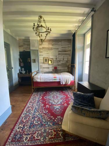 a bedroom with a bed and a large rug at Eco Logis de Chantegrolle in Champagne-Mouton