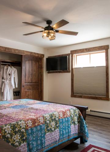 a bedroom with a bed and a ceiling fan at Clear Creek Inn in Georgetown