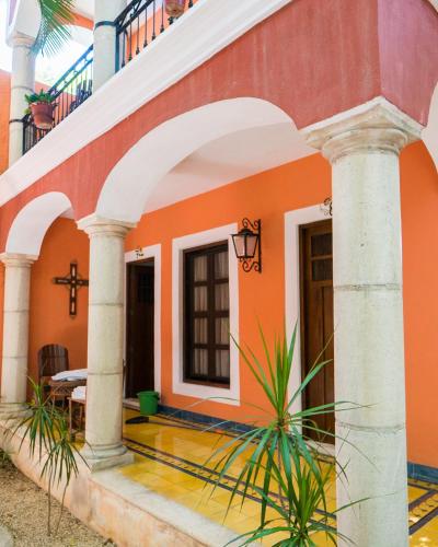 a church with a cross in front of a building at Hotel Casa de las Flores in Playa del Carmen
