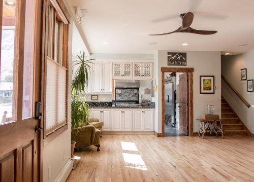 a kitchen with white cabinets and a ceiling fan at Clear Creek Inn in Georgetown