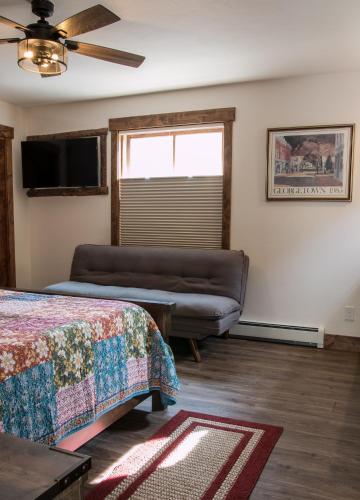 a living room with a bed and a couch at Clear Creek Inn in Georgetown