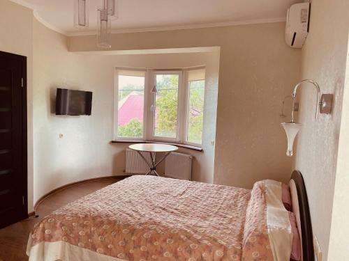 a bedroom with a bed and a window at дача in Odesa