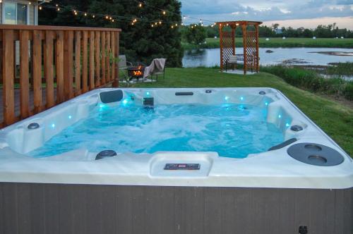 a jacuzzi tub on the side of a yard at McMinnville Wine Country Home with Hot Tub and Deck in McMinnville