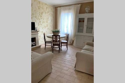a living room with a couch and a table at Casa Flea - Holiday apartment with 2 bedrooms in Gualdo Tadino