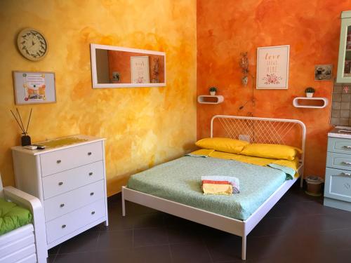 a small bedroom with a bed and a dresser at La Casetta di Manu' a San Pietro in Rome