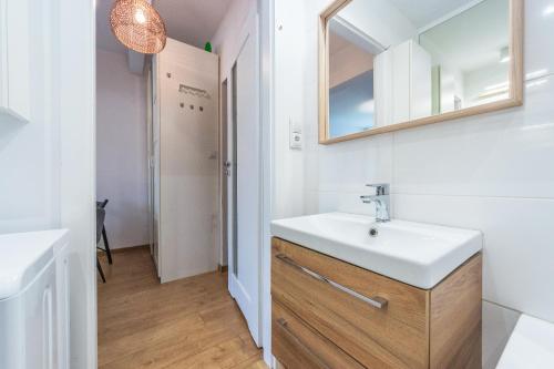 a bathroom with a sink and a mirror at Hello Apartments Dworska LIGHT in Gdańsk
