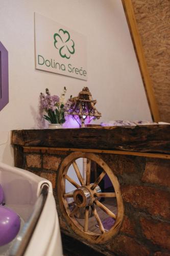 a table with a wooden wheel in a room at Etno Village Dolina Sreće in Vitez