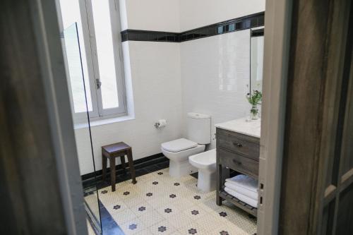 a bathroom with a toilet and a sink and a mirror at Estancia La Paz Hotel in Ascochinga