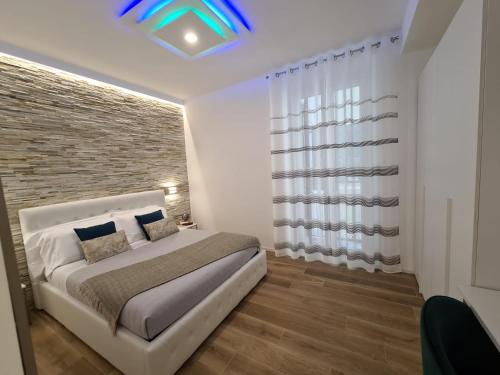 a bedroom with a bed and a brick wall at SONI APARTMENT in La Spezia