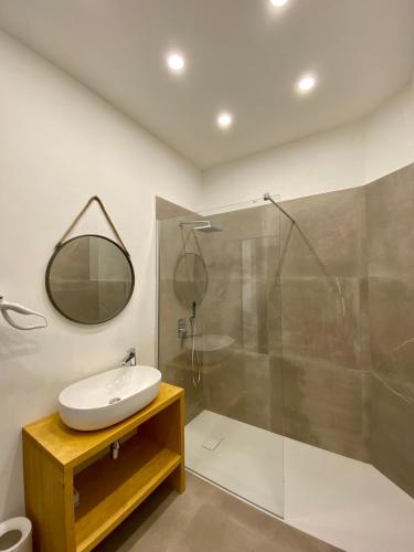 a bathroom with a sink and a shower at Enjoy Olbia in Olbia