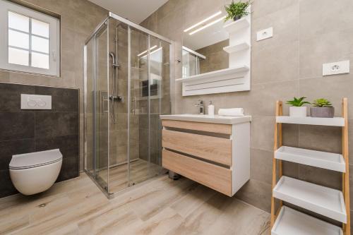 Ένα μπάνιο στο Luxury villa Vid1 with heated pool, jacuzzi and sauna 01 - by TA Leut Agency