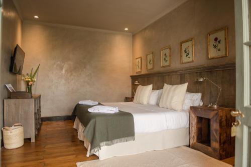 a bedroom with a large bed and a fireplace at Estancia La Paz Hotel in Ascochinga