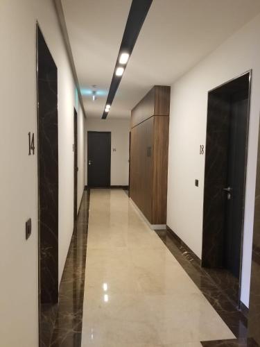 a hallway of an office building with a door and a hallwayngth at Azura Residence - new luxury apartment in Belgrade