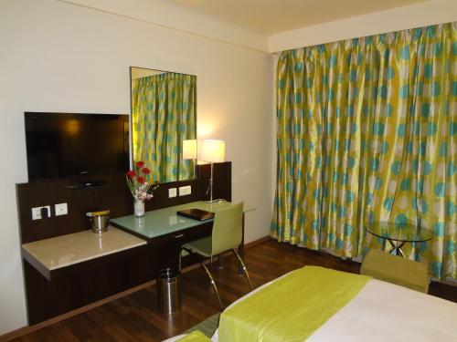 a hotel room with a desk and a bed at Fortune Inn Sree Kanya, Visakhapatnam - Member ITC Hotels' Group in Visakhapatnam